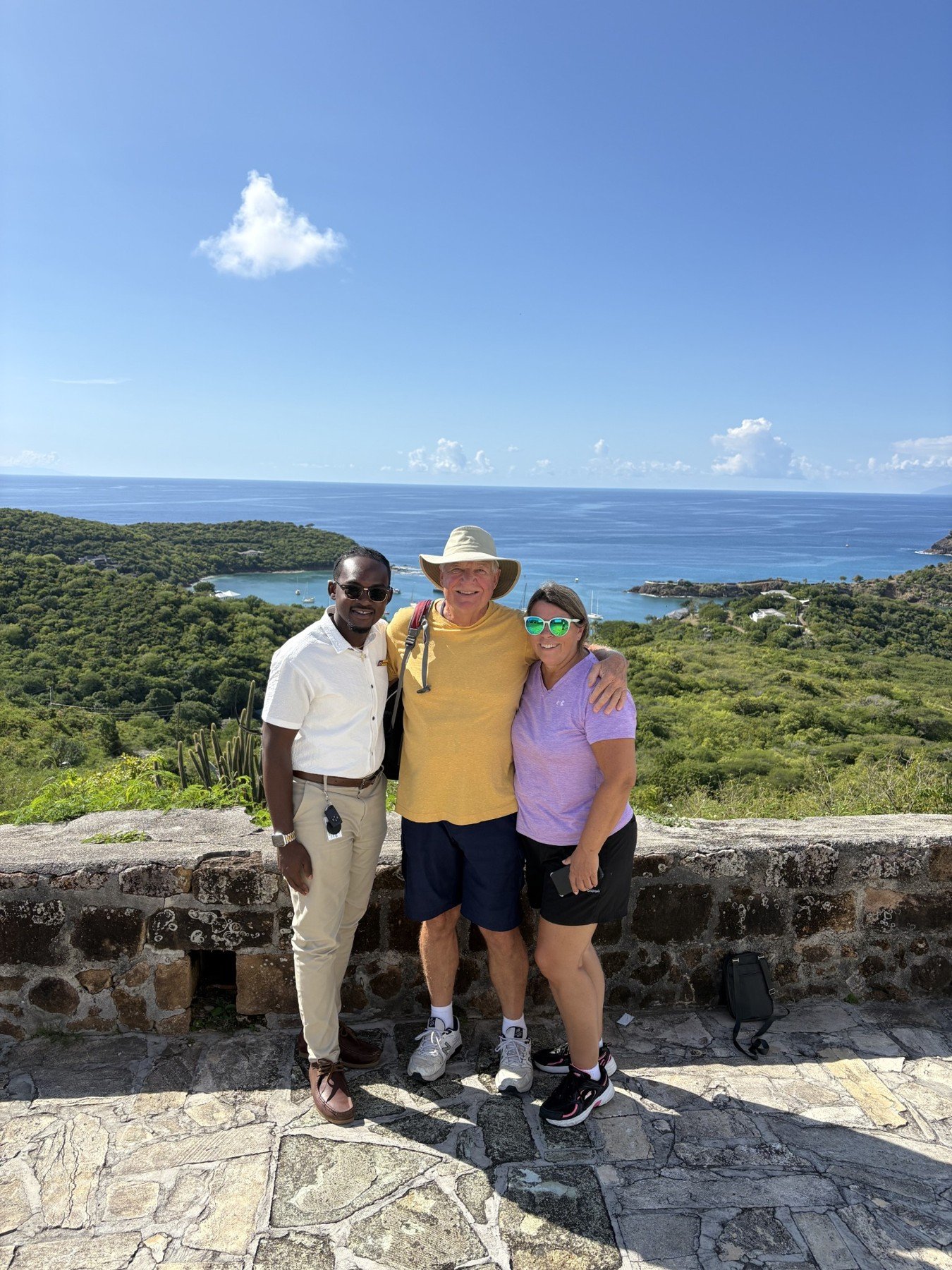 Driver with two guests at a harbour lookout.