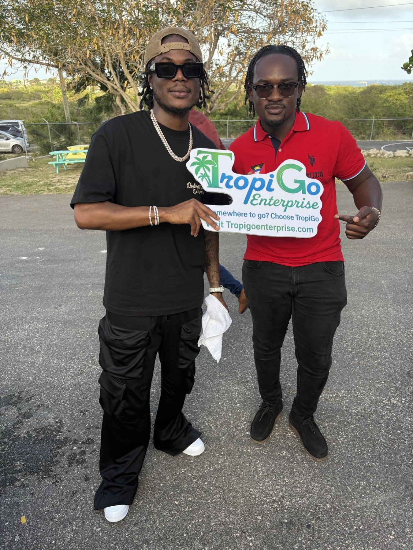 Masicka and a companion holding the TropiGo sign