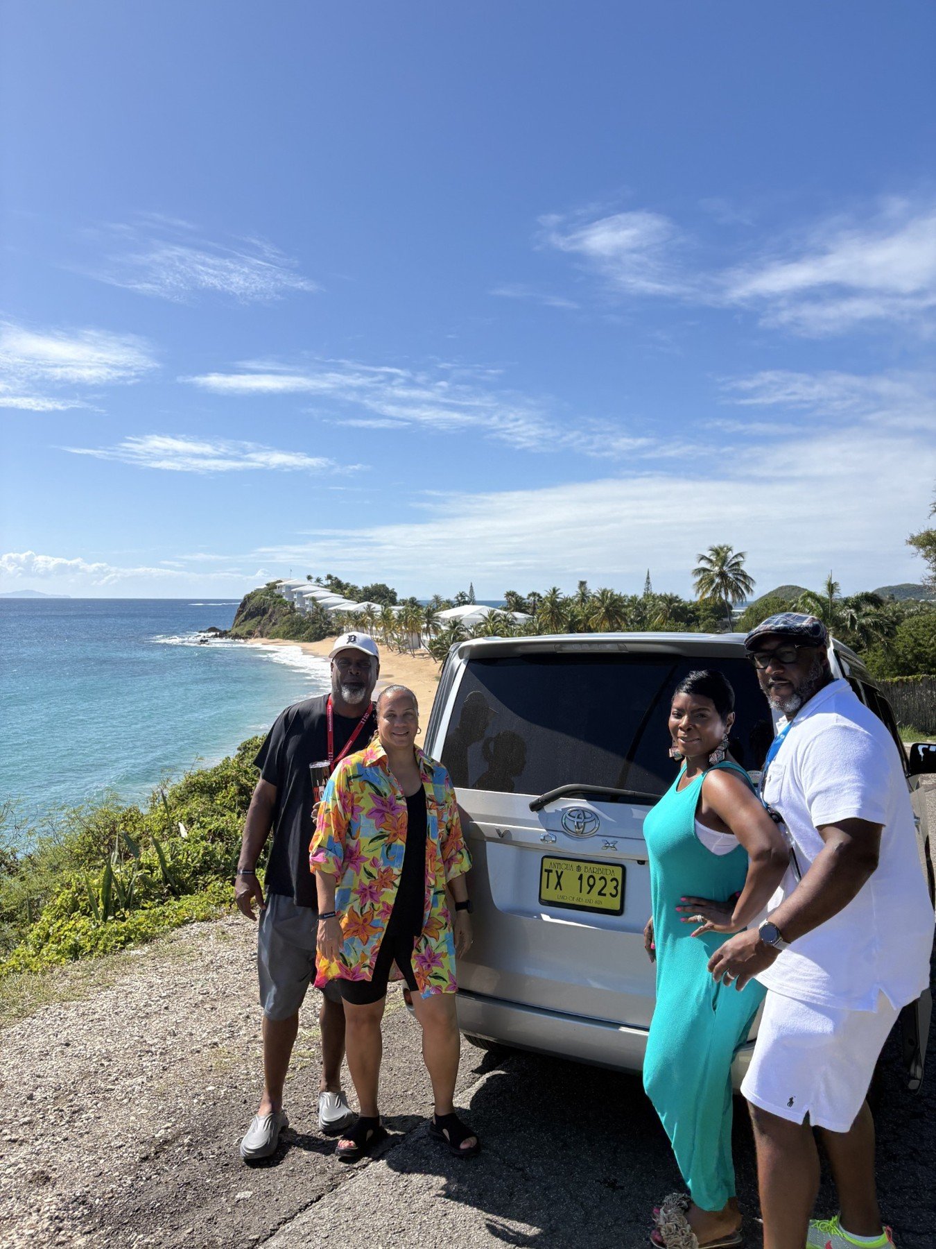 Guests beside the taxi at a coastal lookout.